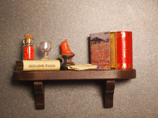 Mini librería con iman a estanteria con soportes en vista, roja