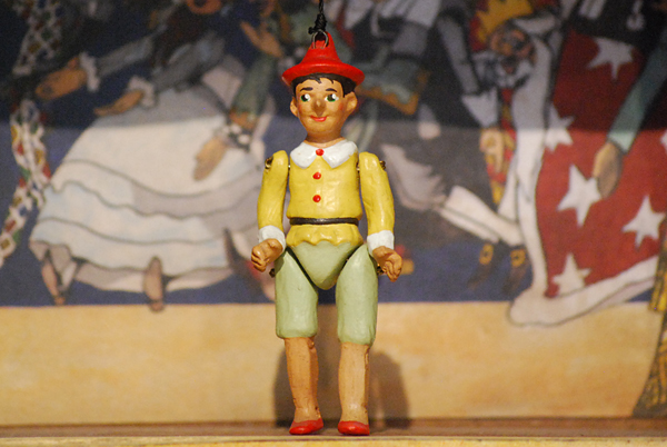 Pinocchio, a small terracotta puppet made up of five hand-decorated jointed pieces