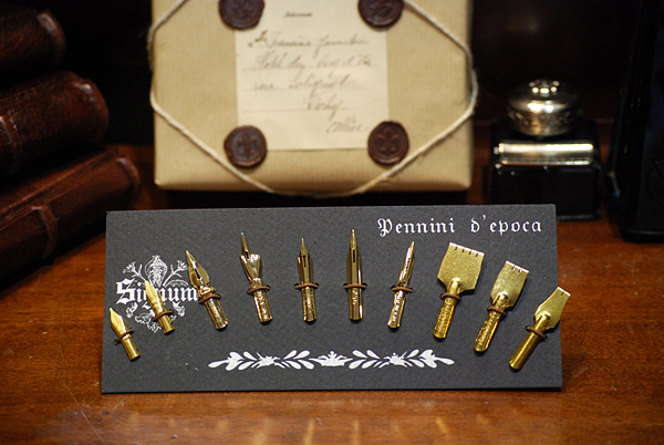 Cartella con dieci pregiati pennini dorati adatti a diverse scritture calligrafiche.
