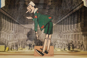 Pinocchio taking a bow, wooden hand-fretworked silhouette of the series 'The adventures of Pinocchio'